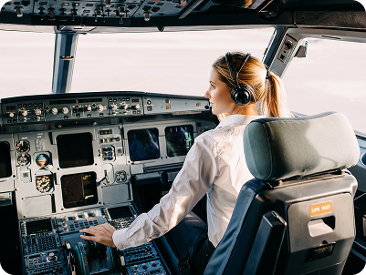 Pilot in a cockpit adjusting controls
