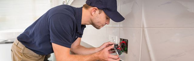 Male Electrician Fixing Wall Socket - Lead Image for Electrician Page