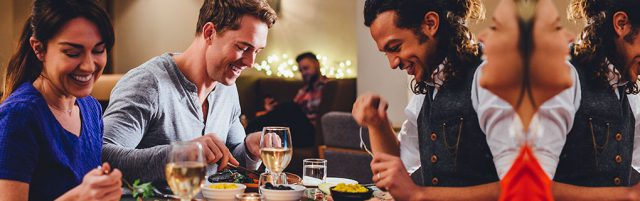 Two Men and Woman Eating at a Restaurant - Lead Image for Family Dining Page