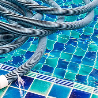 Swimming Pool Hose on Pool - Lead Image for Swimming Pool Service Page